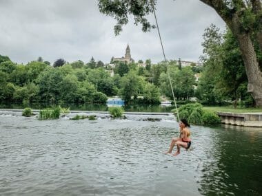 une jeune fille plonge dans une rivière